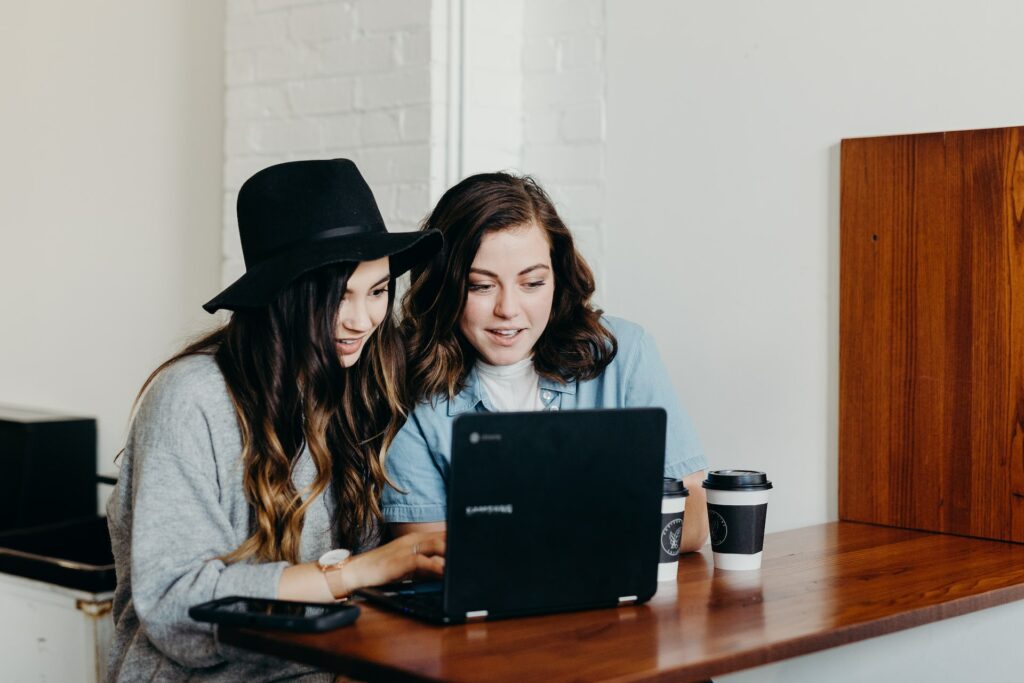 women working together on laptop